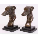 A pair of cast metal models of greyhounds, mounted upon a stepped polished hardstone plinth, h.22cm