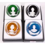 A set of four Baccarat Crystal paperweights, each decorated with busts of Queen Elizabeth II, The