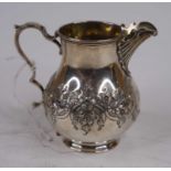 A Victorian silver cream jug, of baluster shape, having a scrolled handle and shell shaped spout,