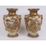 A pair of Japanese satsuma vases, each decorated with figures, h.32cm (a/f)