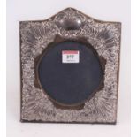 An Elizabeth II silver clad easel photograph frame, repoussee decorated with flowers, height 20cm,