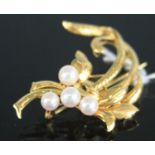 A contemporary yellow metal and cultured pearl set leaf brooch, stamped 18k and 750, tests as 18ct