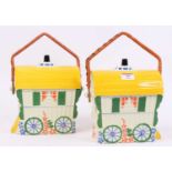 A pair of Old Romany pottery biscuit barrels, each in the form of a caravan, h.20cm