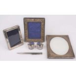 A silver-clad picture frame, having an oval aperture, 17 x 12cm; together with two other smaller;