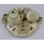 An Art Deco bachelor's breakfast set, comprising teapot, toast rack, teacup, milk and sugar, on a