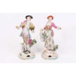 A pair of 19th century French porcelain figures, each shown in 18th century dress, gold anchor