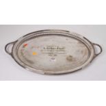 A Victorian silver plated twin handled tray, of oval shape, with engraved inscription 'Presented