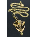 An Art Nouveau yellow metal and green peridot set pendant, on 9ct gold neck chain, gross weight 4.6g