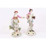 A pair of 19th century French porcelain figures, each shown in 18th century dress, gold anchor