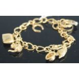 A 9ct gold curblink bracelet, containing assorted charms, gross weight 15.2g Bracelet links
