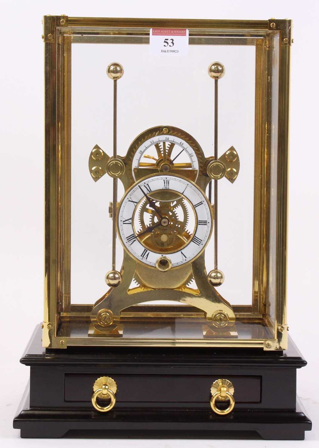 A 20th century brass skeleton clock, the enamelled chapter ring showing Roman numerals, having