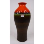 A West German pottery vase, having a mottled red and green glaze, h.46cm