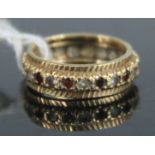 A 9ct gold, garnet and white hardstone set eternity ring, 3.2g, size I