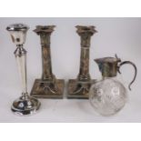A pair of neo-classical style silver plated table candlesticks, each having a corinthian capital