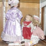 Three 20th century bisque headed dolls, the largest length 55cm