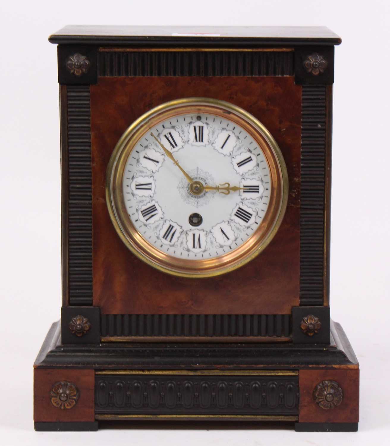 A Victorian ebonised mantel clock, the enamelled dial showing Roman numerals, h.26cm