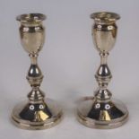 A pair of continental silver table candlesticks, each having a circular sconce over a knopped stem