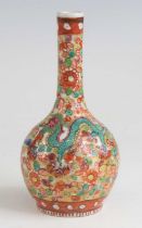 A Chinese blue and white porcelain bottle vase, 18th century, having later European 'clobbered'