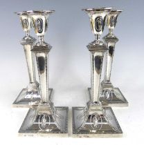 A set of four Victorian silver candlesticks in the neo-classical Adam style, having tapering