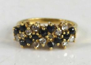 A yellow metal, sapphire and diamond six-row half hoop ring, featuring a row of 2, 5 and 4 round