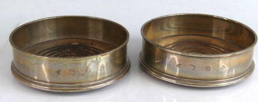 A pair of Elizabeth II silver wine coasters, of plain circular form with everted rims, maker A Chick