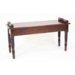 A Victorian style mahogany window seat, having scroll ends and raised on ring turned tapering