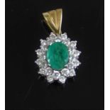 A yellow and white metal, emerald and diamond oval cluster pendant, comprising a centre oval faceted