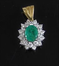 A yellow and white metal, emerald and diamond oval cluster pendant, comprising a centre oval faceted