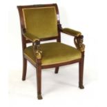 An Empire style mahogany framed armchair, having a dralon re-upholstered pad back and arms,