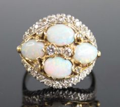 A yellow and white metal, opal and diamond bombe cluster ring, featuring a centre quatrefoil of oval