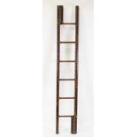 A vintage oak and studded hide bound metamorphic ladder, having six steps and folding into a