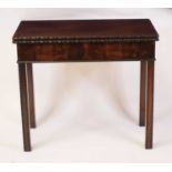 An Edwardian mahogany card table in the Georgian style, the fold-over top with egg and dart