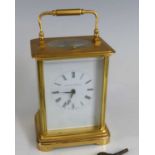 Matthew Norman - a lacquered brass carriage clock, having a signed white enamel Roman dial,