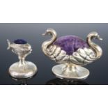 An early 20th century silver novelty pin cushion in the form of two swans, modelled back-to-back
