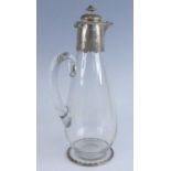 A Victorian silver mounted glass claret jug, having a plain low baluster glass body with applied