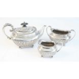 A late Victorian silver three-piece tea set, comprising teapot, sugar and cream, each piece of