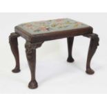 An early George III mahogany dressing stool, having a later woolwork inset drop-in seat, raised on