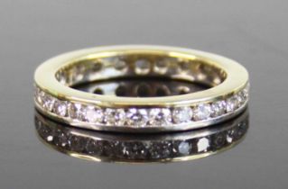 A yellow and white metal diamond full eternity ring, comprising 30 round brilliant cut diamonds in