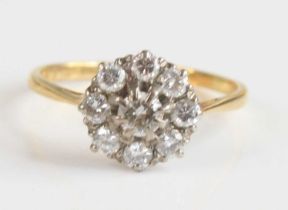 A yellow and white metal diamond circular cluster ring, featuring a centre round brilliant cut