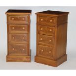 A pair of walnut and figured walnut four drawer bedside chests, each having cross and feather banded