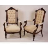 A pair of Victorian walnut and later re-upholstered parlour chairs, each having carved and swept