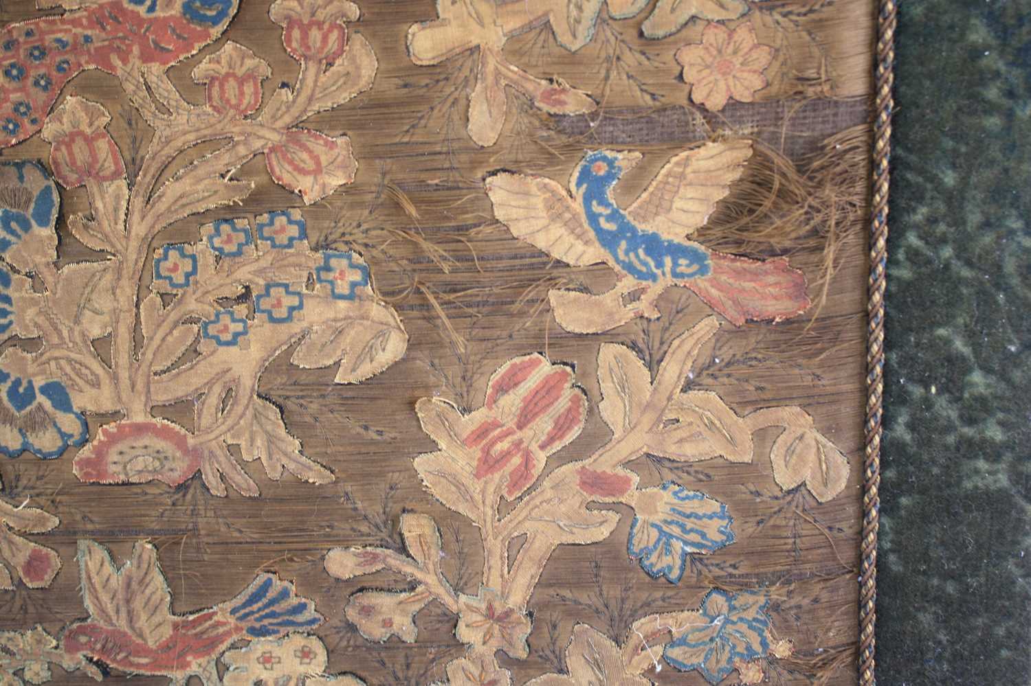 A 17th century silkwork appliqué panel, having tent-stitched silkwork birds upon flowering - Image 7 of 9