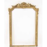 A Victorian carved giltwood and gesso overmantel mirror frame (only), having a beaded slip with
