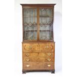 A late Georgian mahogany secretaire bookcase, the upper section having twin astragal glazed doors