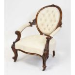 A Victorian walnut framed spoonback armchair, the whole reupholstered in a buttonback cream silk