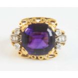 A yellow and white metal, amethyst and diamond dress ring, featuring a centre cushion cut amethyst