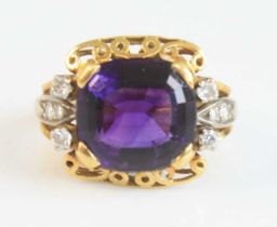 A yellow and white metal, amethyst and diamond dress ring, featuring a centre cushion cut amethyst