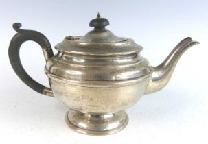 A George VI silver teapot, of plain banded squat circular form, having ebonised C-scroll handle with