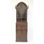 A Victorian Gothic Revival oak secretaire bookcase, of narrow proportions, showing the influence