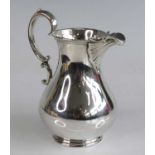A Victorian silver cream jug, the pear shape plain body with reeded rims, having S-scroll handle and